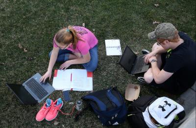 Students studying on the lawn.