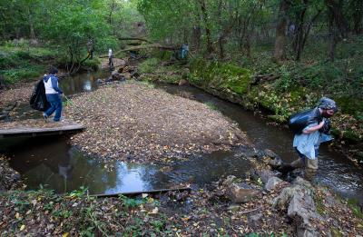 Chai Vang, left, and Kegan Tierney help clean up Galloway Creek.