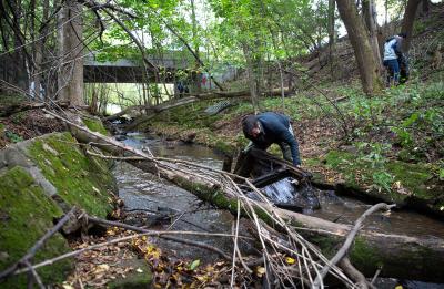 Assistant Professor Keith Gilland removes part of a couch from the creek.