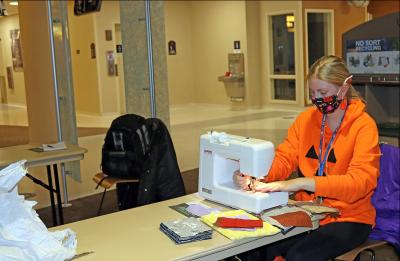 UW-Stout student Leah Dischinger sews together face masks that a group of students are making for elementary school children and others in need.