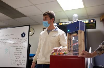 UW-Stout student Nicholas Wasieleski explains the candy machine he and fellow student, Cody Lohrenz, built in their Mechatronics 371 class.