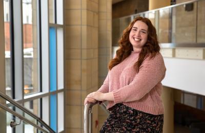 Erica Gaetz, human development and family services graduate, pictured in the Memorial Student Center grand stairwell.