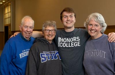 Nathan Thompson, a third-generation student, poses with his family in Harvey Hall.