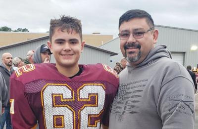 Adam Richards, supply chain management graduate, and his son at a Menomonie Mustangs game.