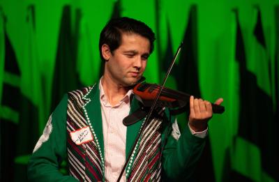 A student plays live music at the 2019 International Night Expo.