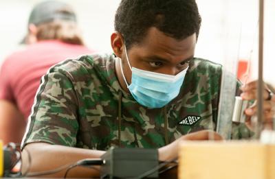 A student studying in the physics lab.