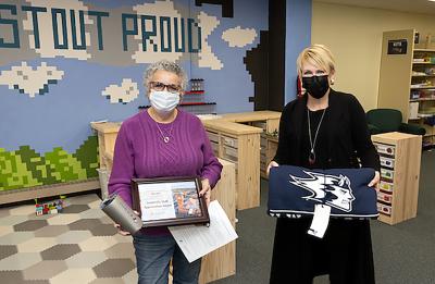 Kim Uetz, left, receives the January University Staff Appreciation Award from Chancellor Katherine Frank.
