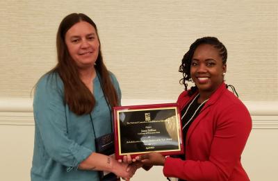 Jamie Stillion (left) receiving her NCRE award.