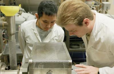 Joshua Bernin and Luke Bickelhaupt work with the extruder in the Food Process Engineering Research Lab.