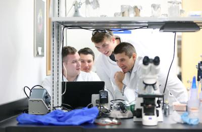 Lab Manager Josiah Ray and students in the microbiology lab