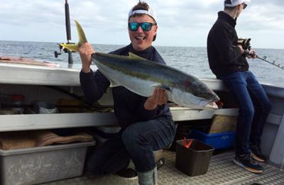 Klobucar shows off a kingfish he caught while in New Zealand.