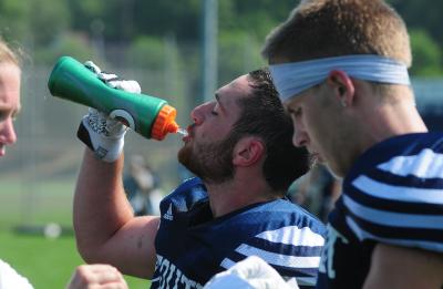 Football player drinking water from a water bottle