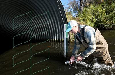 Stout students collected sample of river water for lab test.