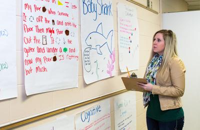 School psychologist engages with student work.