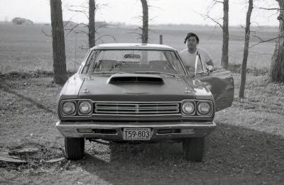 Arthur Nakatani standing next to a car