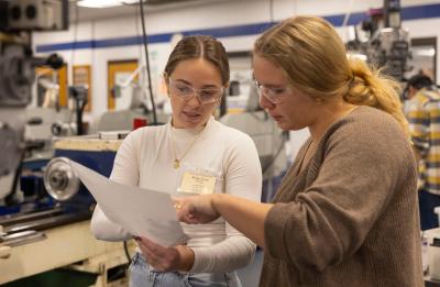 Morgan Young and Grace Thoreson review engineering plans