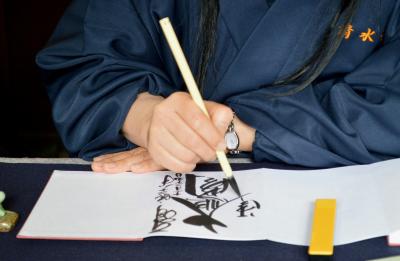 Hand with a Japanese brush creating calligraphy 