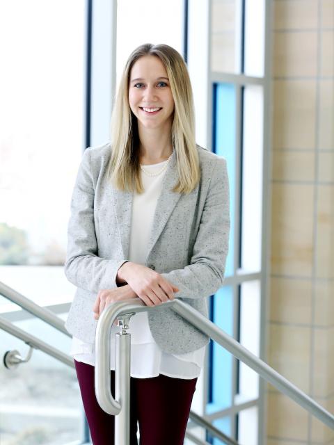 Inspiring graduate, Holly Solomon, in the Grand Staircase at Memorial Student Center.
