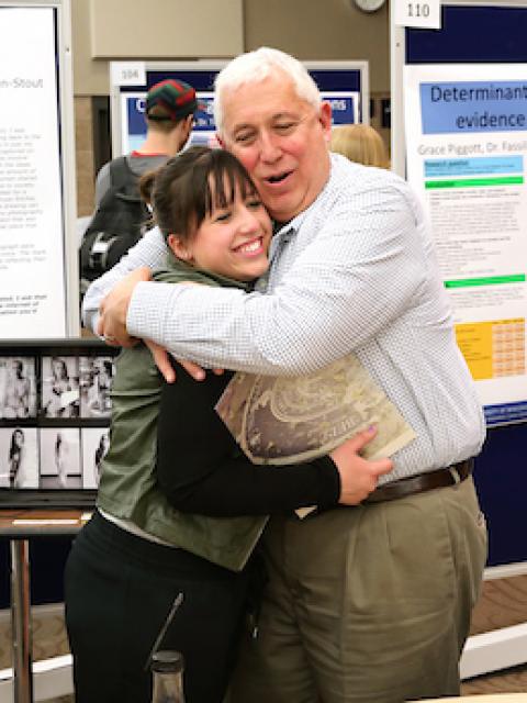 Research Day featured poster and oral presentations by 106 students and 84 faculty, April 2015. Pictured is student Katelyn Ferguson receiving a hug from a family member after receiving award.