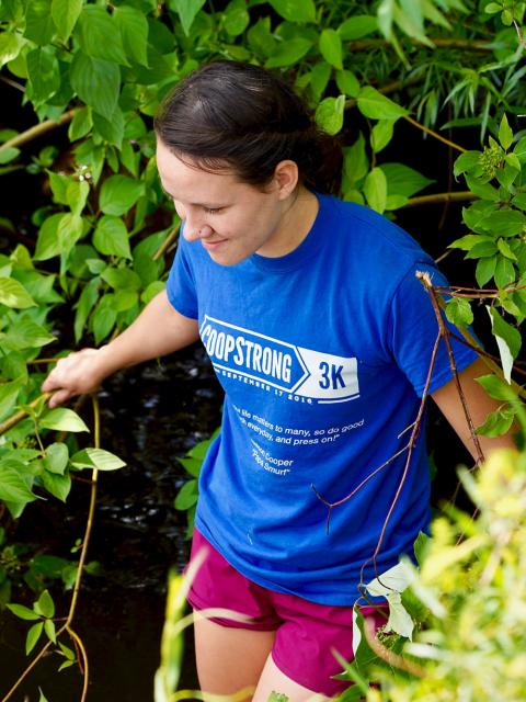 Madeline Tripp walking through lakeside foliage