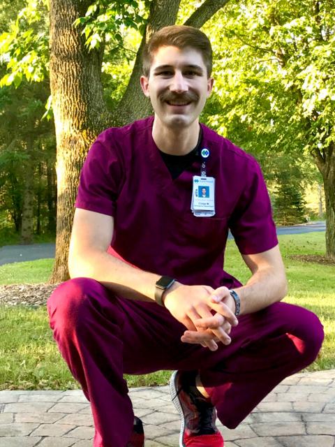 ABMB graduate Craige McConnell in his medical scrubs.