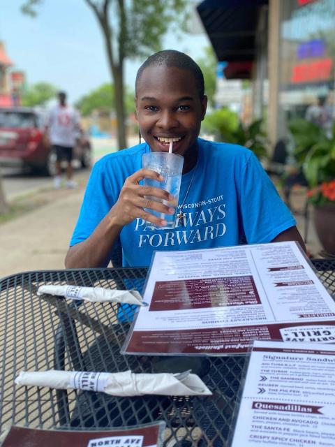 Deon Canon, Gilman Scholarship recipient, at an outdoor cafe.