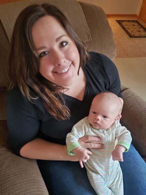 Online digital marketing technology student Angela Marquardt with her baby at home.