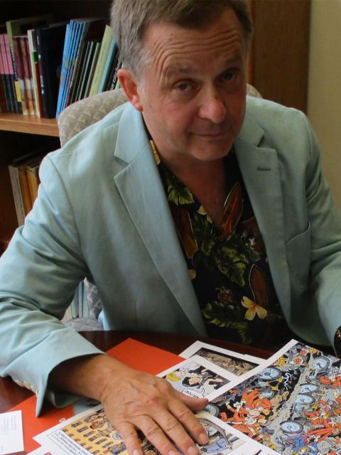 Ken Avidor proofing copies of his graphic novel "Bicyclopolis"