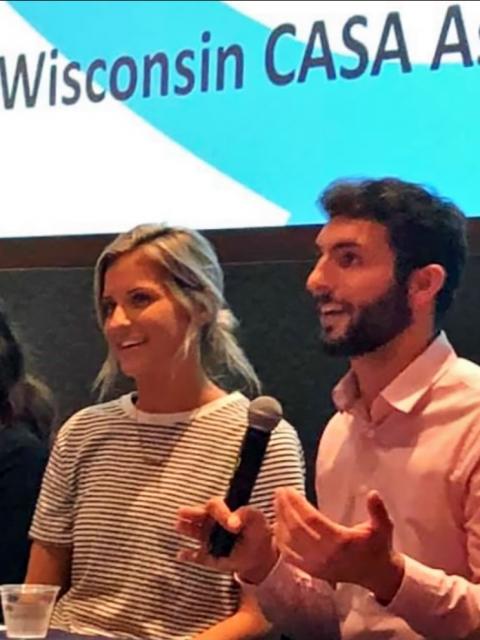 Olivia Johnston speaks at a Court Appointed Special Advocates event in Green Bay with UW-Stout alum Cameron Hunter.