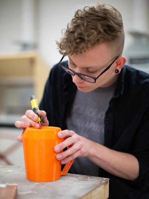 A UW-Stout student works on a project in the ceramics lab.