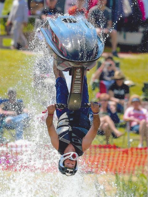 Alum Jed Copham, who was a “total daredevil,” does a backflip with a jet ski.