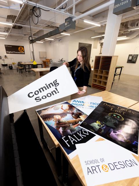 Kerstin Nye, a Master of Fine Arts in design student, uses the new wide-format inkjet printer in the new lab.