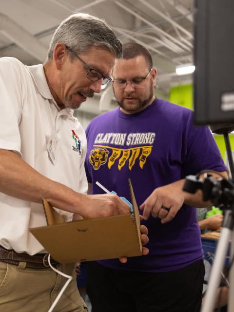 Fab Lab instructor Laurence Charlier works with a teacher from Clayton during the 2021 WiFab West workshop.