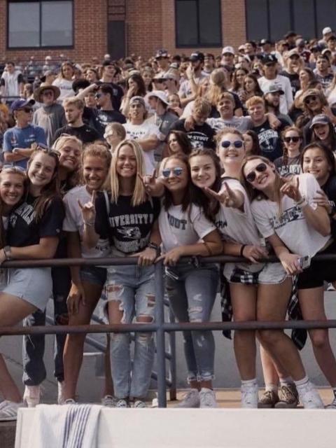 Stout Scholar Erin O'Brien with friends at a Blue Devils football game.