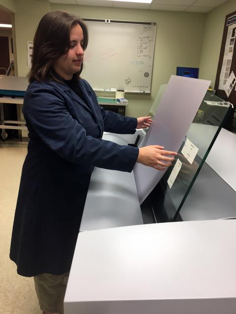 Cali Scholes, a graphic communications major, inserts an offset printing plate into a Kodak computer-to-plate imaging device in a UW-Stout lab.