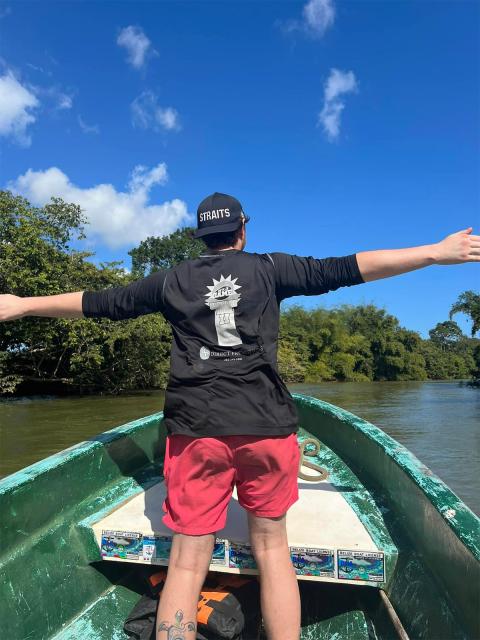 Hunter Kuester at the front of a boat on a tour of the Sittee River and mangroves. Photo by Hunter Kuester