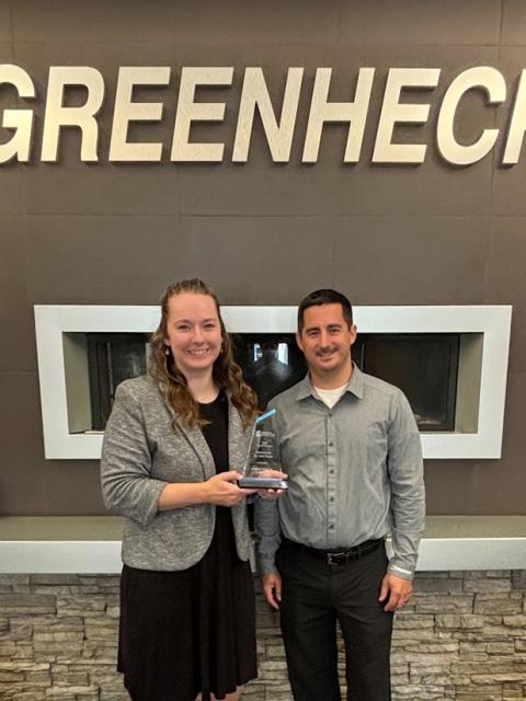 Anna Brown and Tom Zompolas from Greenheck Group hold the 2024 Employer of the Year award presented to the company by UW-Stout’s Career Services.