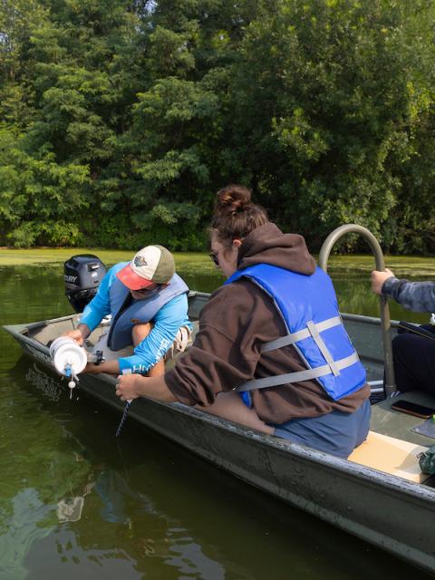 Three people in a small boat