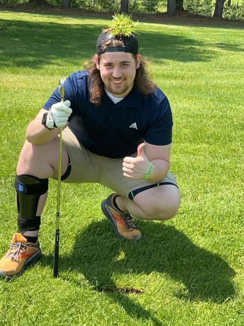Man kneeling on golf course