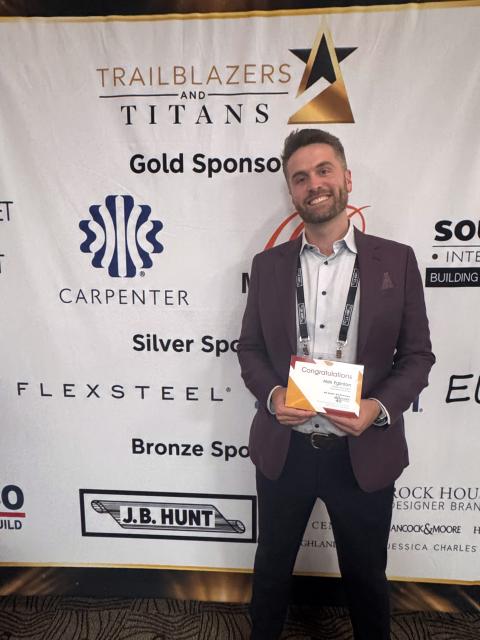 Man holding framed award